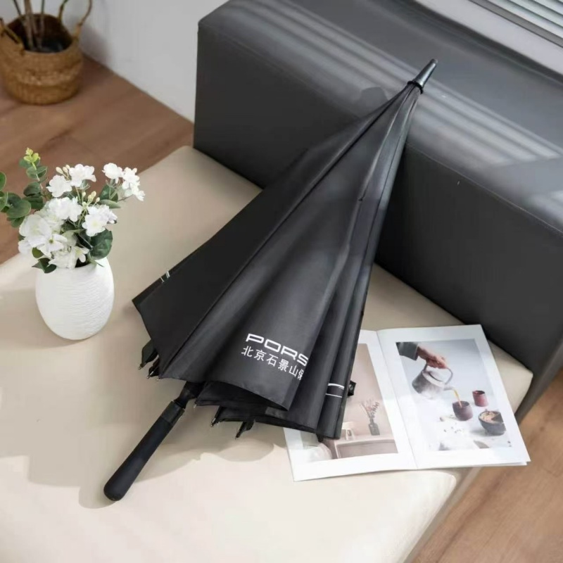 Closed black golf umbrella featuring an ergonomic rubber straight handle