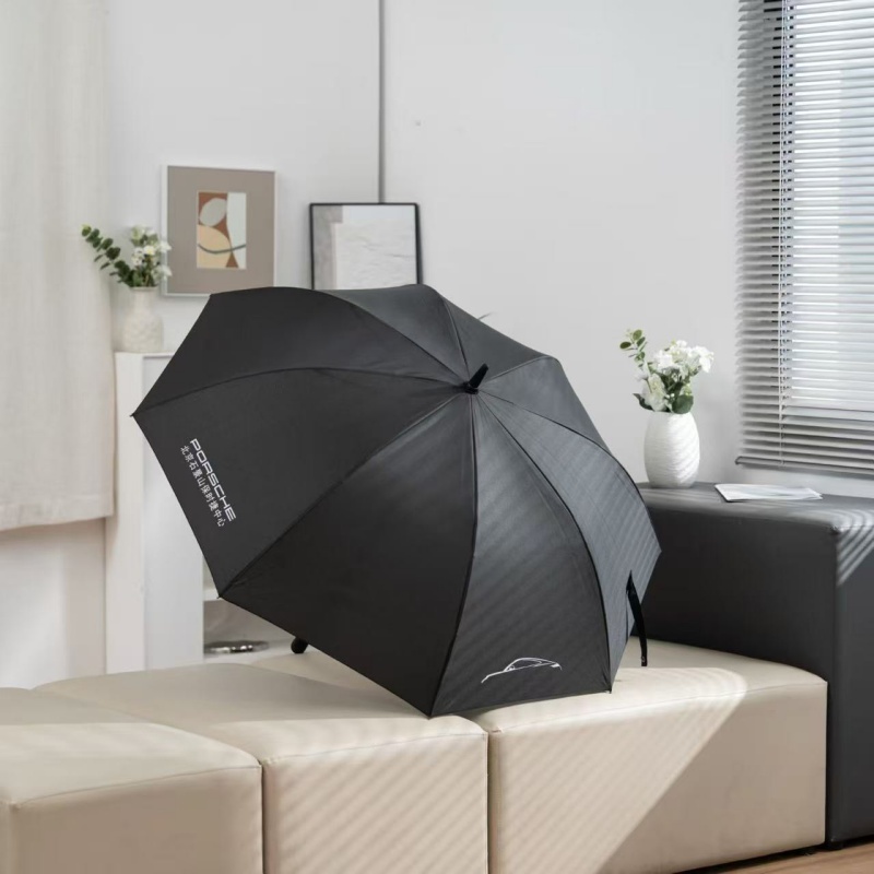 Fully opened black custom automotive golf umbrella showing branded canopy panels